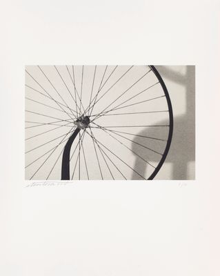 a black and white photo of a bicycle wheel