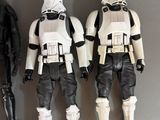 three star wars action figures are lined up on a table