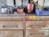 an old wooden cabinet with many items on top of it