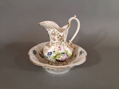 a white pitcher and a bowl on a table