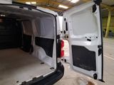 a white van with its door open in a garage