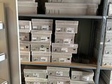 a lot of boxes on the shelves in the room