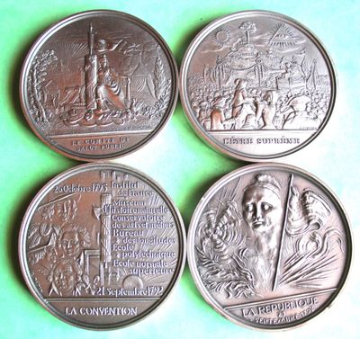 four silver coins with a picture of a man and a woman on them