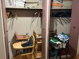 a baby high chair in the corner of a closet