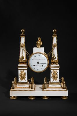 an image of a white and gold clock sitting on top of a table