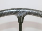 a close up of a steering wheel with a plastic wrap on it