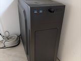 a black computer sitting on the floor next to a wall