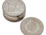several coins are stacked on top of each other on a white surface