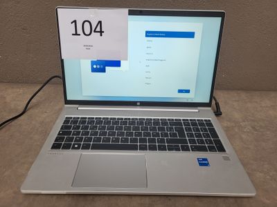 a laptop computer sitting on a table with a clock on the screen