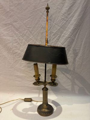 a lamp that is sitting on a table with a black shade