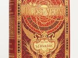 un livre rouge avec des lettres dorées posé sur une surface blanche