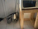 a microwave sitting on top of a wooden table