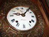 a clock that has roman numerals on the face of it