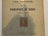 an old book sitting on a table with a shadow of a person