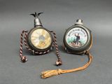 two clocks that are sitting next to each other on a table