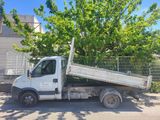 a white truck that is parked next to a tree