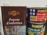 several cans of paint sitting on a counter top next to a can of paint