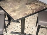 a table and chairs in the corner of a room