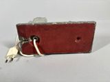 a close up of a small red box with a key in it
