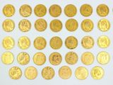 some gold coins are arranged in a circle on a white surface