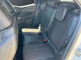 the back seats of a car with a bottle of water in the passenger seat