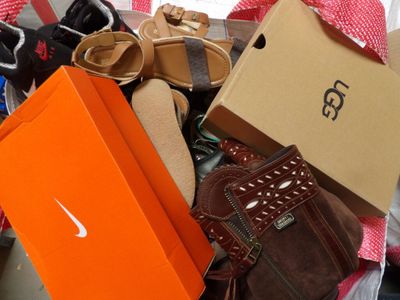 a pile of shoes and a box on the floor