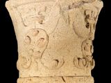 a close up of a stone vase with a design on it