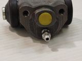 a close up of a steering cylinder on a white surface