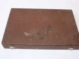 a brown suitcase sitting on top of a white table