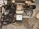 a machine that is sitting on the floor next to a bunch of wires