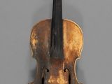 a close up of a violin on a gray surface