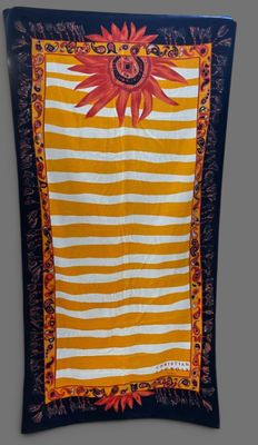 a yellow and white striped wall hanging with a sunflower on it