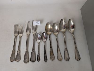 a lot of spoons and forks on the table
