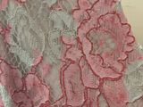 pink and white lace fabric with pink flowers on it