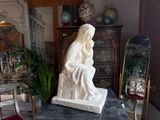 a statue of a woman sitting on top of a table
