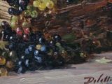 a painting of grapes in a basket on a table