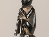 a statue of a monkey sitting on top of a table
