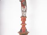 a statue of a boy with a top hat on top of a table