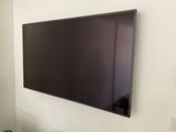 a flat screen tv mounted on a wall in a living room