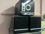 two speakers sitting on top of each other on a shelf