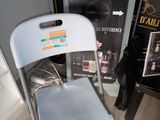 a white chair sitting next to a box of hair products