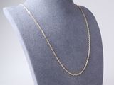 a close up of a mannequin with a gold chain on it