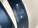 a close up of a person holding a black leather belt