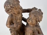 statue of a boy and a girl sitting on a rock