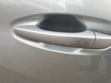 a close up of a car door handle with a sticker on it