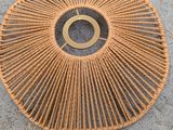 a close up of a rattan bag on a concrete surface