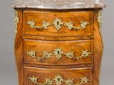 an antique wooden chest of drawers with marble top