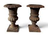 pair of antique wooden vases on stands on a white background