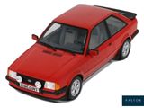 a red toy car that is sitting on a white surface