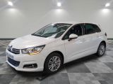 a white citrole is parked on a checkered tile floor